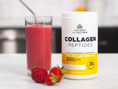 bottle of Collagen Peptides Vanilla next to a strawberry smoothie