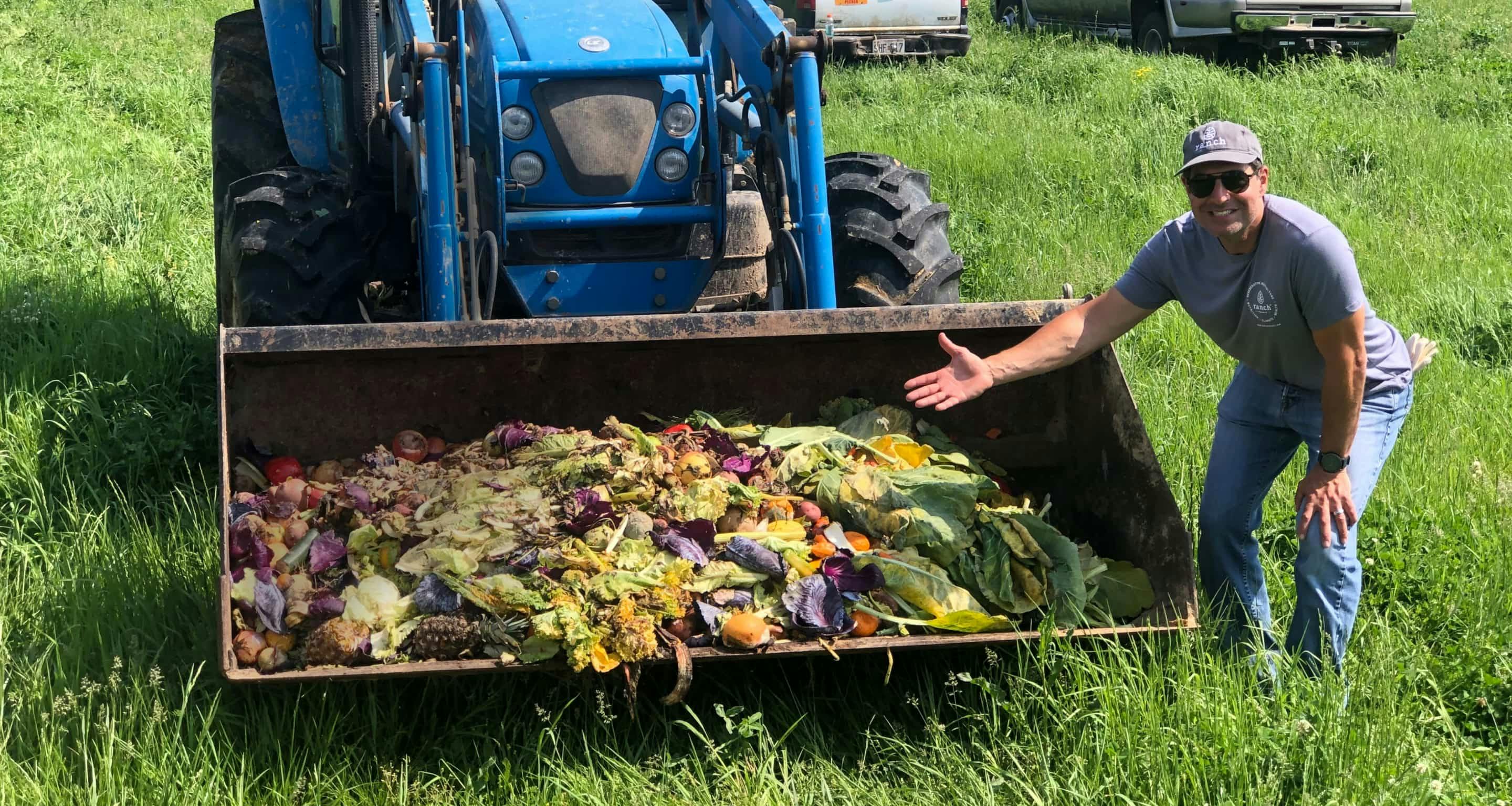 Jordan Rubin in front of a tractor full of food