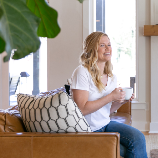 Woman drinking coffee on a leather chair