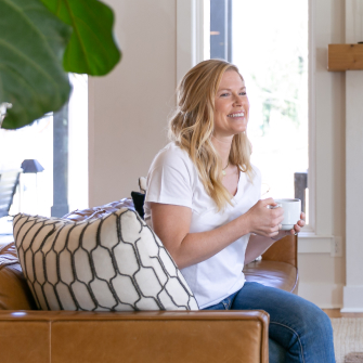 Woman drinking coffee on a leather chair