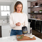 woman scooping bone broth protein chicken soup 